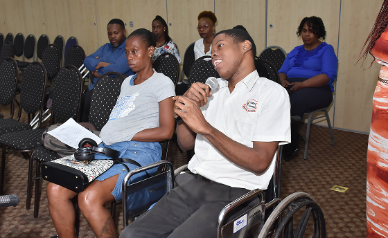 Young man in wheelchair holding microphone